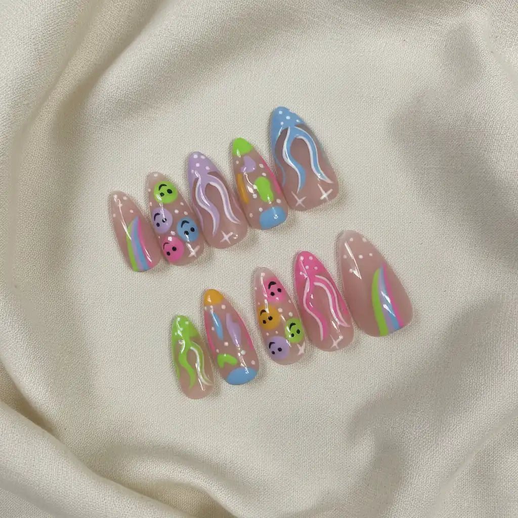Happy Vibes Handmade Press-On Nails — smiley faces and rainbow patterns on almond shape | MOONLEE