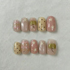 Sweet Bow Handmade Press-On Nails — pastel pink with gold bow and star accents on oval shape | MOONLEE